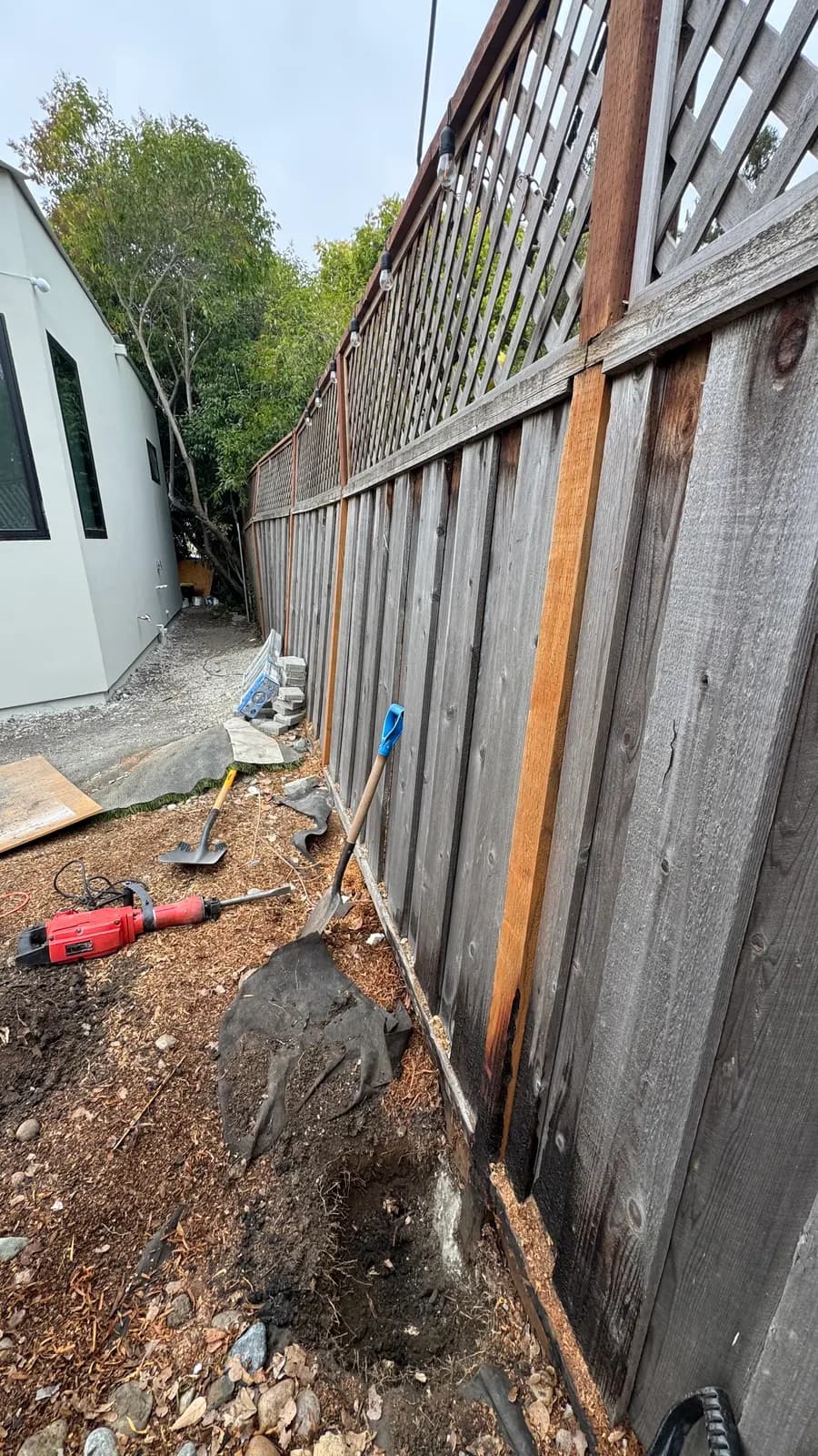 Fence line before the repair: charred boards and failing posts, Palo Alto